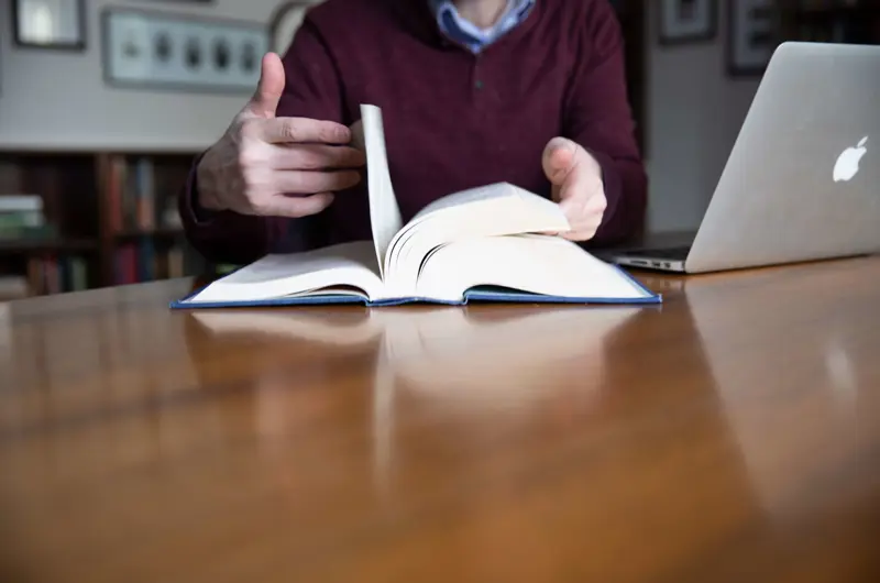 hands flipping through book