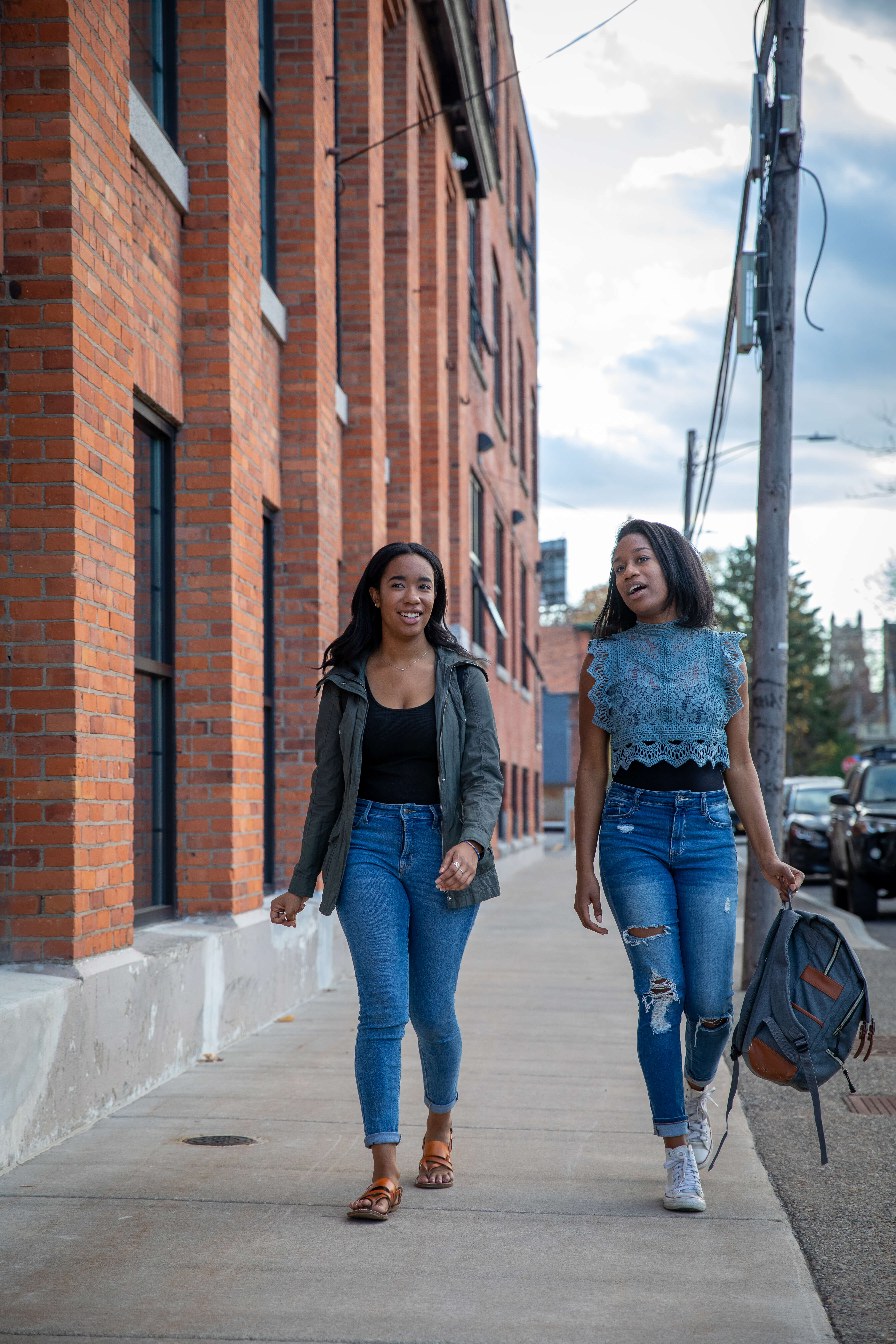 two women students walking and talking