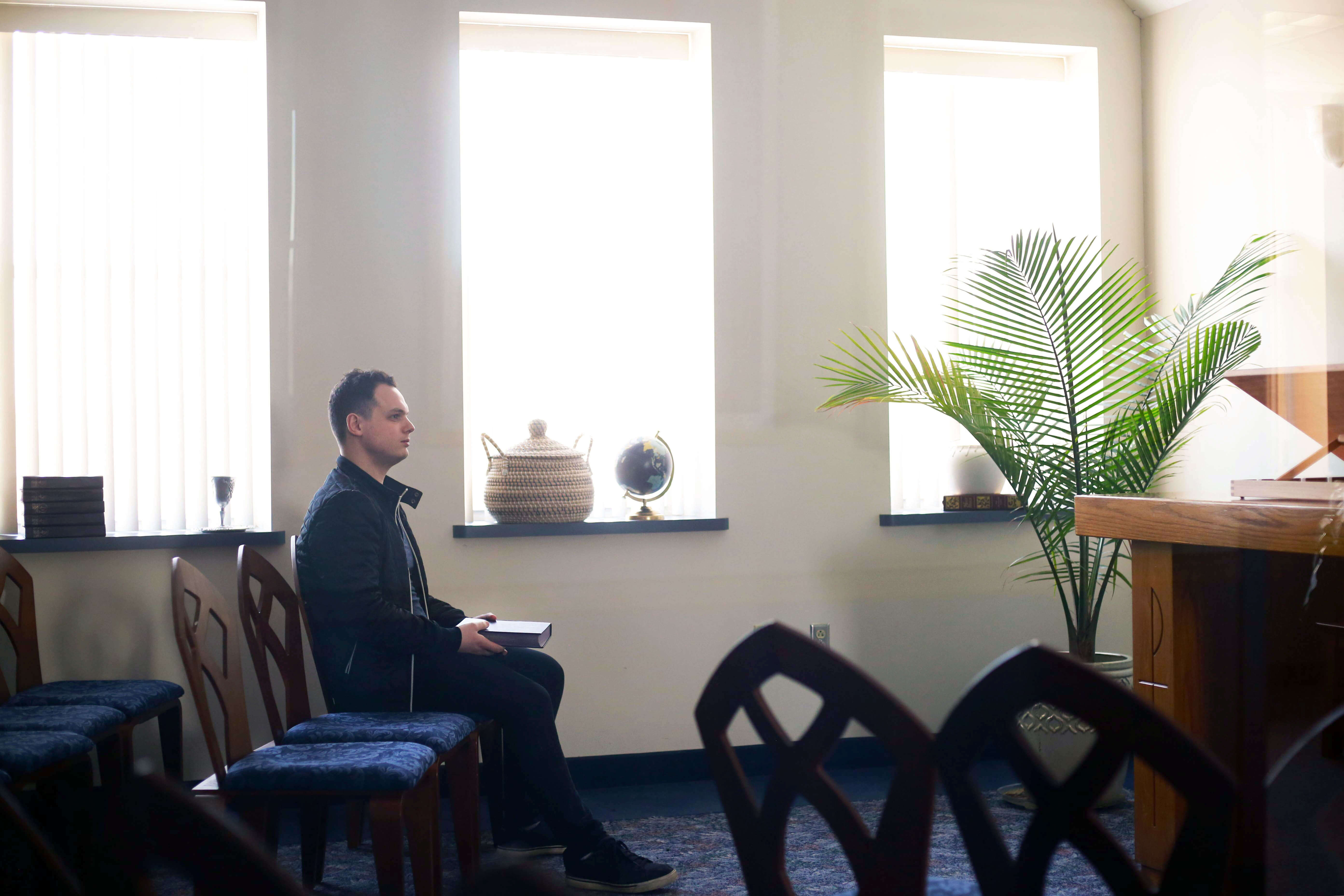 student sitting in chapel