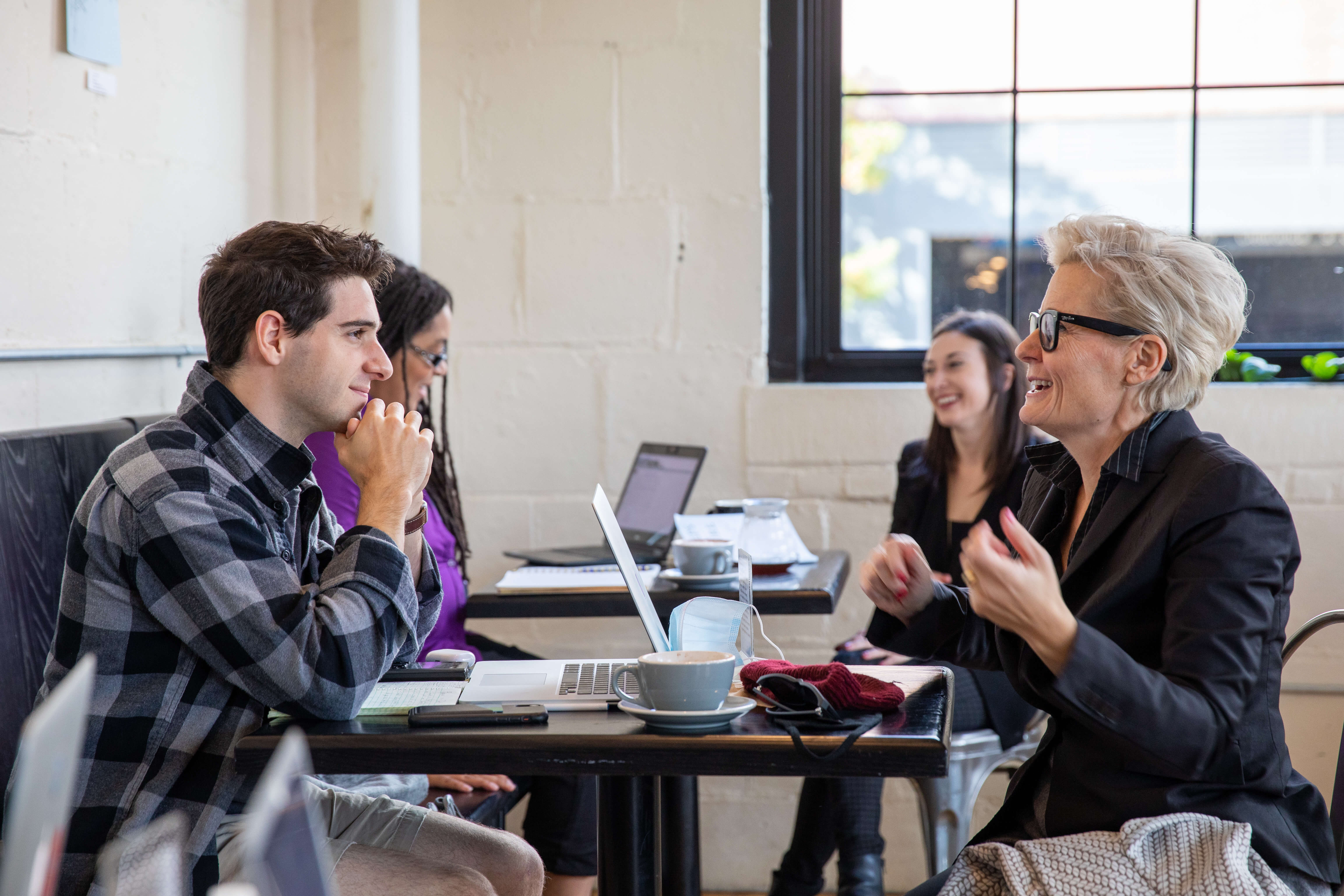 Group of students laughing and working together
