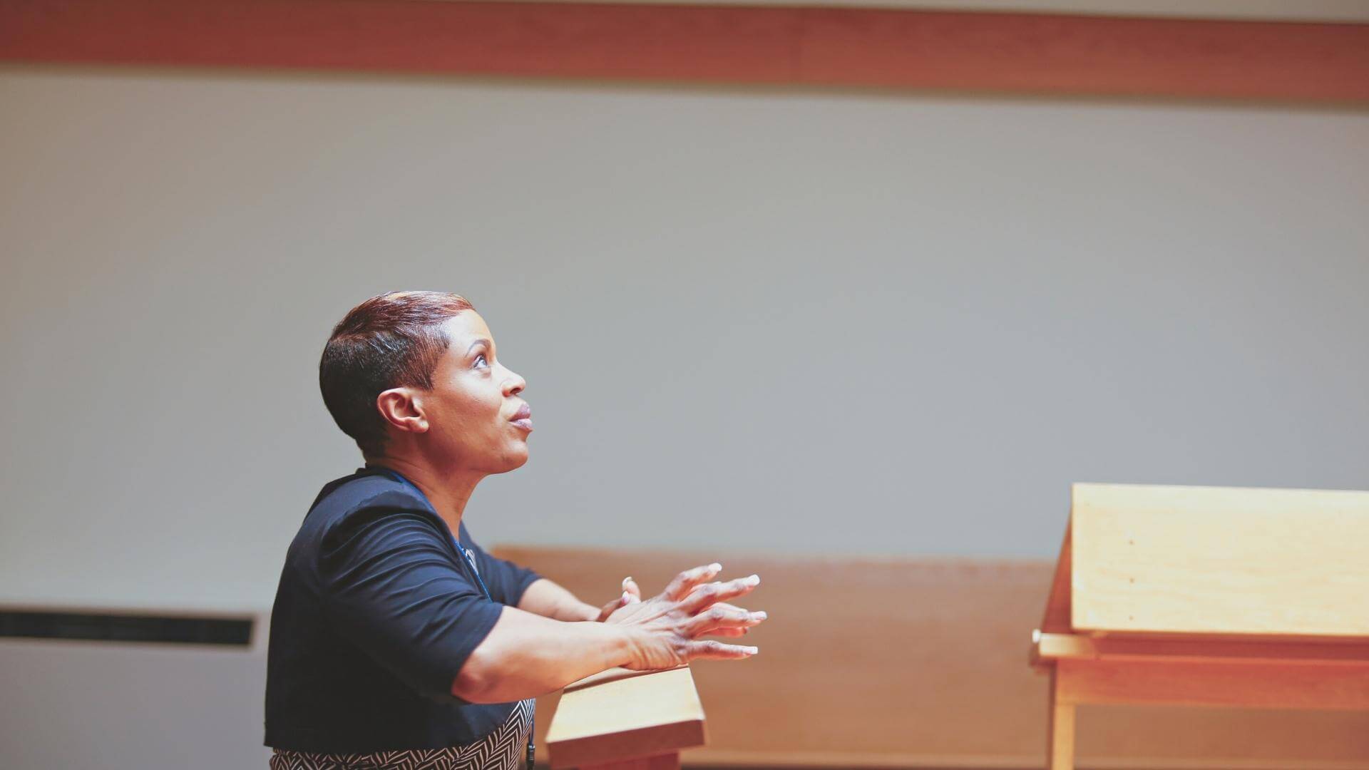woman kneeling looking up in prayer