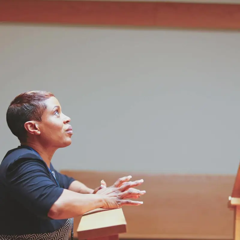 woman kneeling looking up in prayer